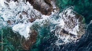 White foam wave crash on rocky reef in sea, Aerial top view footage of fabulous sea tide