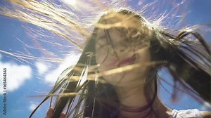 Hair of pretty little girl hair is blowing in the wind