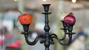decoration element. candle holder that supports three onions instead of candles. inventiveness. 4k video.
