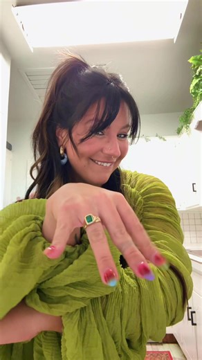 Stunning Emerald Engagement Ring on the Ring Finger