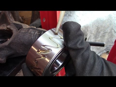 Pressing a wheel bearing with a hydraulic press.