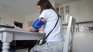 Holter monitor device and daily blood pressure recorder on human female body. Daily cardiogram monitoring. Health care and disease prevention