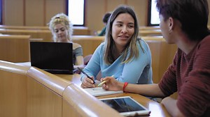 students sitting in a classroom with laptops