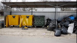 Accumulation of garbage. Yellow and green garbage bins. Sorting waste. Plastic bags with garbage. Helping the environment. Ecology and protection concept