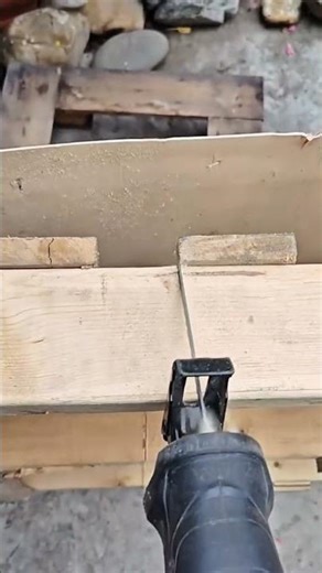 Cutting wood precisely with a reciprocating saw in an outdoor workshop for a construction project