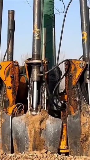 A heavy machine that is being used to move trees easily