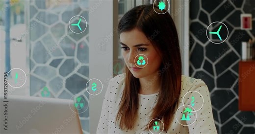 Woman at table using laptop on load, energy icons floating over face and laptop, assessing options