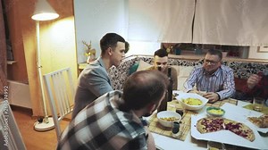 company of friends talking and laughing at the table