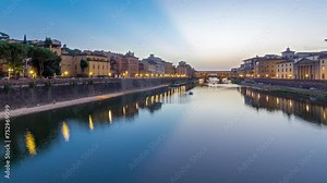 River Arno and bridge Ponte Vecchio day to night transition timelapse after sunset from Ponte alle Grazie in Florence, Tuscany, Italy. Lights reflections on the river with evening illumination