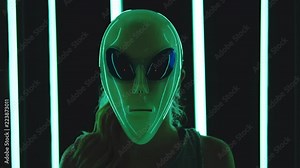 Portrait of caucasian blonde straight hair woman wearing an alien mas - surreal, eccentric concept
