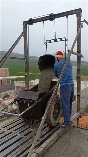 Pouring concrete with a mixer. Please support us workers.