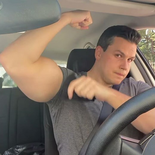 Flexing the biceps in the car