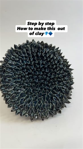 Orli Ivanov on Instagram: "So many little cuts, so many little crystals 💎🔷💠 This wall sculpture is part of my Void Series — inspired by cosmic forms, geology, and the repeating geometry of crystals. Almost like opening a geode and peering into another universe. In this step-by-step guide I show how I build it: first cutting tiny clay triangles, reshaping them into diamonds, then layering them one by one onto a bowl-like form. The result: a piece that feels like it pulls you inward. If you’d l