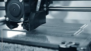 3D printer. 3D printing. Process operation working of 3D printer close-up. 3D printer printing model from molten plastic filament. Three-dimensional technology. Additive manufacturing technologies.