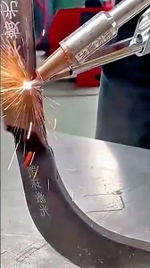 Intense welding sparks dramatically shower from torch joining two metals