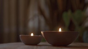 Two burning candles on table