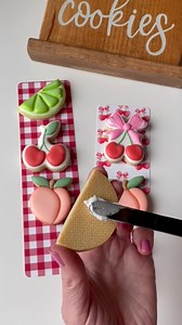 These fruit cookies paired with our tall backers make perfect party favours for summer gatherings! 🍒🍑🍋‍🟩 These tall backers are greaseproof and food safe. I’m using a stiff royal icing to “glue” them onto the backers, then packaged them in our 3x13” cellophane bags. I finished off the look with our red pre tied bows **PROMO: we are offering 2 FREE cookie cutters to go with these specific backers. Visit our website for details (under the “Cherries and Gingham “backers listing ) - there you wi