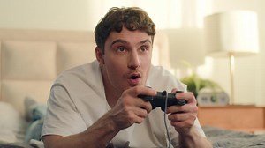 Excited Caucasian man male guy playing console joystick game entertainment laughter smiling virtual winner online competition web bedroom enjoyment pastime electronic control technology cyber