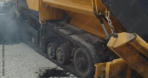 Paving of the road, heavy machinery, asphalt paver with steaming hot asphalt, 4k