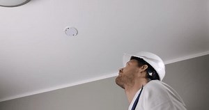 clip-1110755475-fire-safety-engineer-installing-photoelectric-smoke ...