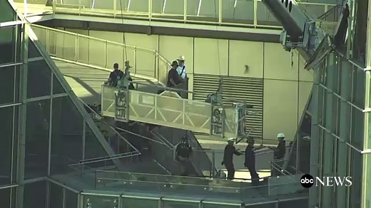 'This is TERRIFYING:' Wind-whipped window washers rescued from 50-story tower