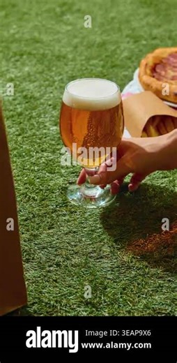 Refreshing beer with snacks and fast food in dynamic lifestyle stop motion on vibrant backgrounds. Concept of street food vibe, spontaneous moments, social hangout, indulgence and everyday enjoyment Stock Video Footage - Alamy