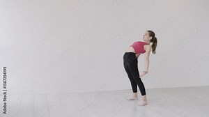 The girl arches her back and stands in a bridge pose, standing on her hands and feet