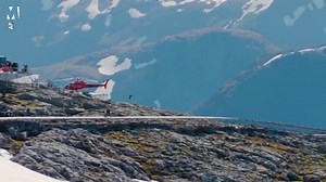 Tom Cruise rides motorcycle off a mountain and parachutes down