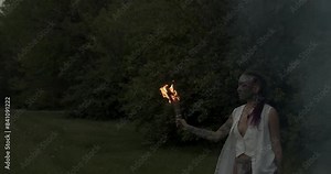 The vibrant energy of Beltane! This video captures the spirit of the Celtic fire festival with a focus on a woman adorned with beautiful face paint, dancing in the warm glow of the bonfire.