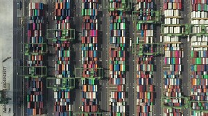 Stunning aerial view of the port of Singapore with trucks and thousands of colored containers ready to be loading on the cargo ships. The Port of Singapore is the second biggest port in the world.