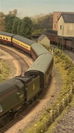 OO model steam passenger train on the railway