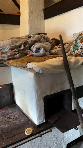 A traditional Eastern European masonry stove designed to retain heat, used for cooking, warming the home, and even sleeping on.📹cirstean.iosif