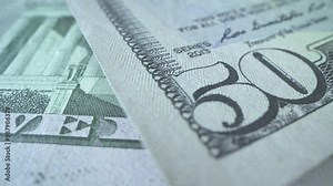 Many bills of USD on the table. 50 american dollars in macro shot with watermark on it. Strong and powerful currency in the world. Cash money. Business concept