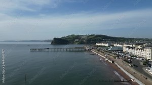 Teignmouth, South Devon, England: DRONE VIEWS: Teignmouth Pier and the seafront; the Ness escarpment in the b/g. Teignmouth is a popular UK holiday resort in the summer months.