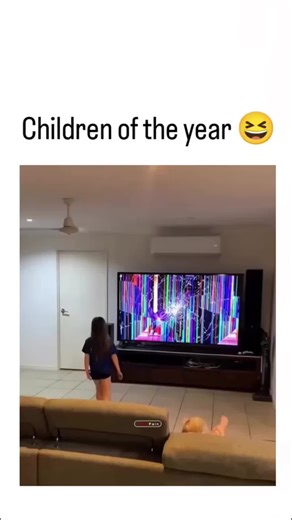 @imamul_boy_01 on Instagram: "The video depicts a mother in a living room frantically tossing her toddler onto a couch after noticing colorful glitches on their large TV screen, implying the child caused the damage, with the caption "Children of the year " poking fun at the chaos. Posted on December 2, 2025, it exploded to 1.9 million views and 57k likes within hours, drawing mixed replies: some criticize the forceful throw as risky child-handling, while others share memes appreciating the over-