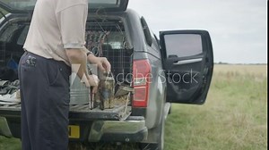 Apiarist preparing a smoker for the hive at the back of his vehicle
