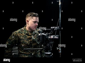 U.S. Marine Corps Corporal Joshua Munsen, a video producer with Marines Production, Defense Media Activity, sets up cameras for a video interview with Maj. Gen. Lorna Mahlock, commander of Cyber National Mission Force, U.S. Cyber Command, on Fort George G. Meade, Maryland, Feb. 20, 2024. During the interview, Maj. Gen. Mahlock explains the crucial role cyberspace plays for the Department of Defense.  Marine Corps Stock Photo - Alamy