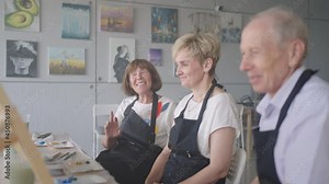 Elderly men and women share their impressions of the drawing courses. Emotions of a senior people talking together. Activities for older friends