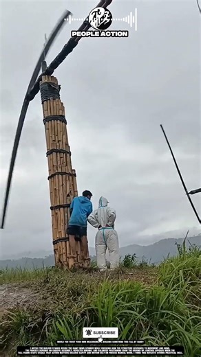 Builder Checks Giant Wind Spinner Stability After Manual Assembly Process