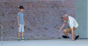 Breakdancing. Young man makes dance moves in an urban setting. Breaking as a dynamic and acrobatic form of street dance. Body tricks showcase the dancer's agility, balance, and control.