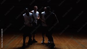 A basketball players in a huddle putting their hands in the middle and breaking