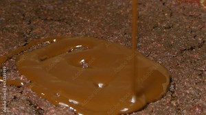 Pouring delicious melted dark chocolate on vegan Red Velvet beetroot cake, 4k preparation, detail