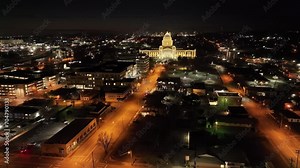Arkansas State Capitol building at night in Little Rock, Arkansas with drone video wide shot stable at an angle.