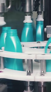 Liquid detergent on automated production line. Clip. Automated production line of washing fluid. Machinery for bottling
