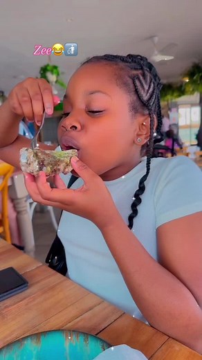 Young Girls Enjoying Oysters in Colorful Restaurant