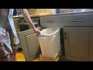Automatic slide out kitchen garbage bin.