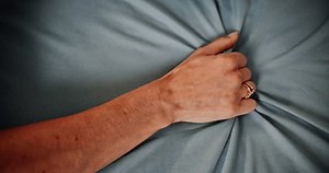 clip-3508215289-closeup-hand-woman-grab-sheet-fabric-love