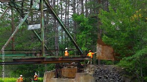 Workers preparing a bridge demolition - Filmed on a construction site as part of the demolition of an iron railway bridge in Canada