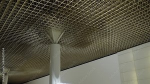 This image captures the sophisticated architectural design of a ceiling in a modern public building, showcasing the detailed work and contemporary style. Intricate Ceiling Design at a Public Facility