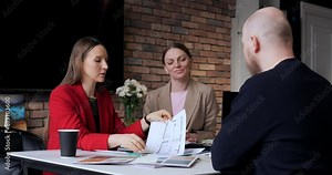 Businesswomen sealing deal with handshake in modern office, showcasing successful deal. Smiling and satisfied, success in negotiations and business partnership, emphasizing importance of deal.